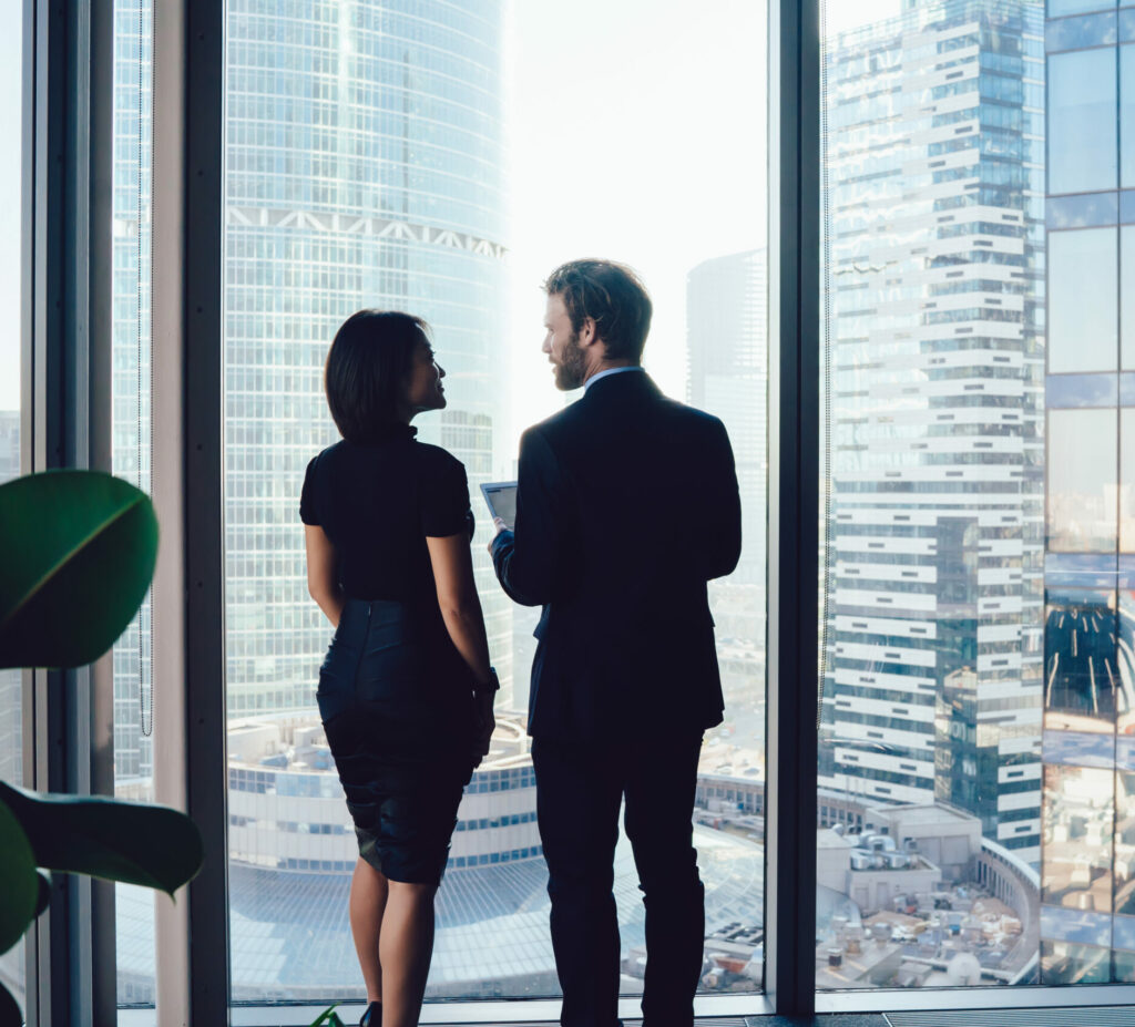 Confident colleagues talking about business project in office