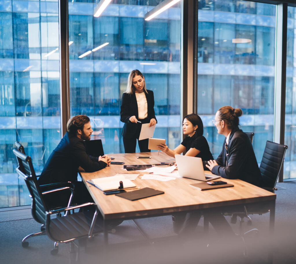 Diverse group of colleagues working on project together in boardroom